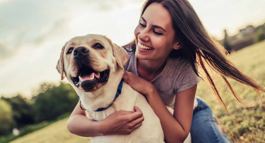 young woman with yellow labrador