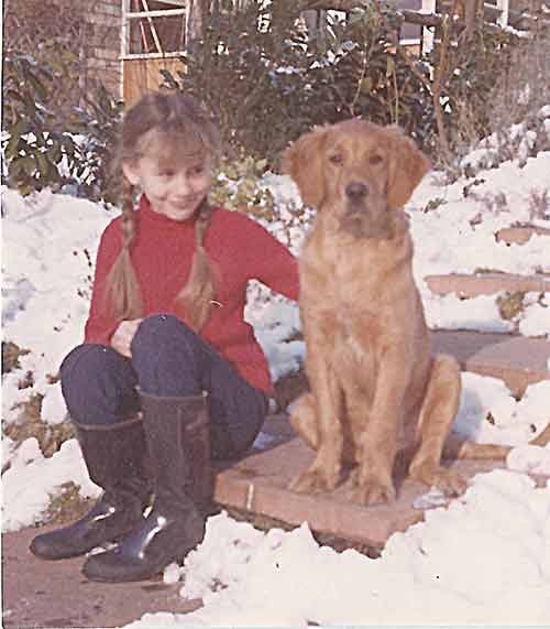 photo of the author as a child with a golden retriever puppy